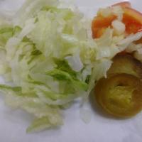 Vegan Burrito · Bean and Spanish rice rolled with lettuce, diced onions, tomato, jalapeño and Texas taco sau...