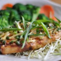 Ginger Seabass · Grilled Chilean seabass, topped with sesame soy ginger sauce and green onions. Served with s...