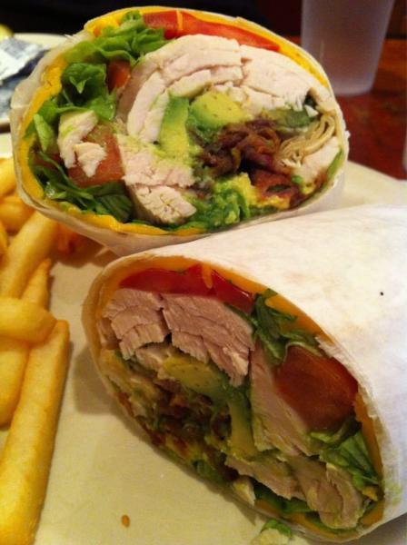 Turkey BLT Wrap · Sliced turkey breast with bacon, lettuce, tomatoes and melted cheese. Served on a flour tortilla with coleslaw, pickles and French fries.