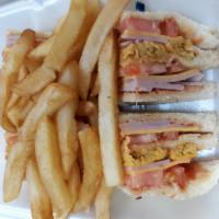 Dominican Club Sandwich · Served with fries and soda