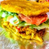 Patacon Plantain Sandwich (Pork) · Fried plantain filled with pork, cheese, lettuce, tomatoes and special house sauce.