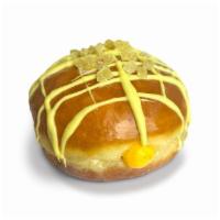 Mango Ginger Kiss · Raised glazed doughnut filled with mango cream, drizzled in ginger icing, and topped with a ...