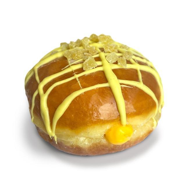 Mango Ginger Kiss · Raised glazed doughnut filled with mango cream, drizzled in ginger icing, and topped with a kiss of seductive crystallized ginger