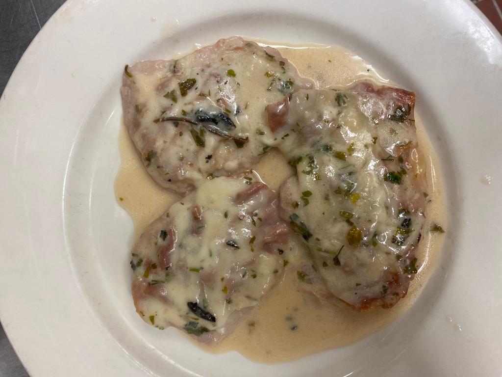 Saltimbocca alla Romana with Veal · Veal topped with prosciutto and Swiss cheese sauteed in a Marsala and cream sauce with sage.