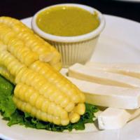 11. Choclo con Queso · Peruvian corn with cheese and spicy creamy cheese sauce.