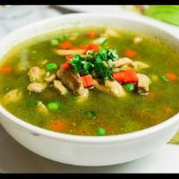 Aguadito de Pollo · Green vegetable soup with rice and chicken giblets.