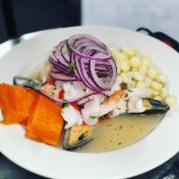 17. Ceviche Mixto · Mussels, squid, shrimp and fish. Diced fish marinated with lime juice, onions, garlic, cilan...