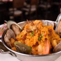 Paella Matiz · Saffron rice mixed with mussels, clams, shrimp, calamari, scallops, green peas, Spanish chor...