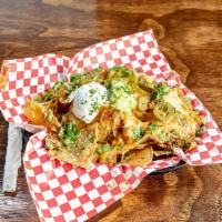 NinthInning Nachos · The mound of tortilla chips with refried beans, cheese, chili, jalapenos, sour cream.