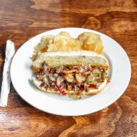 Philly Cheesesteak Sandwich · Thinly sliced steak, grilled onions & bell peppers topped with melted provolone cheese. Serv...