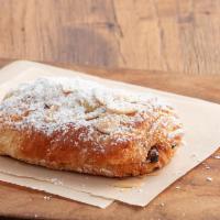 Chocolate Almond Croissant · Belgian chocolate croissant filled with rich almond cream, topped with sliced almonds and do...