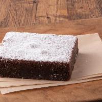 Fudge Brownie · A fudge brownie topped with powdered sugar.