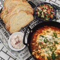 Shakshuka · Served with Challah bread, 2 poached egg in a Tunisian tomato & pepper sauce and side salad ...