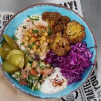 Shuk Bowl · Served with 2 pita. Hummus, msabbaha, cauliflower, chopped salad, red cabbage, pickles and t...