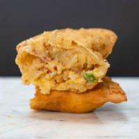 Loaded Potato Empanada · Seasoned mashed potatoes, bacon, cheddar, sour cream and scallions.