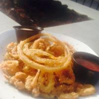 Calamari · hand cut & lightly breaded calamari paired with fried onion slices, served with sweet chili ...