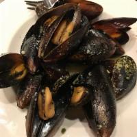 Mussels · sautéed in garlic & butter served in white wine or red sauce with garlic bread slices