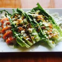 Wedge Salad · with crispy bacon, diced cucumbers, bleu cheese crumbles & tomato wedges