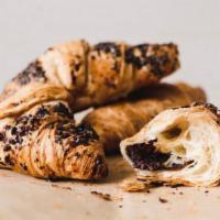 Chocolate Croissant · Buttery brioche dough, laminated with rich European butter, filled and dipped in Belgian dar...