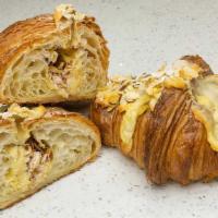 Almond Croissant · Twice baked butter croissant filled and topped with almond frangipane and sliced almonds.