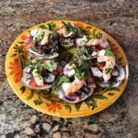 Ostiones la Playa · Freshly opened and cleaned oysters topped with octopus, shrimp, onions, cilantro, and tomato. 