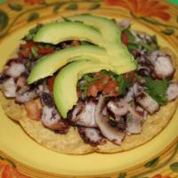 Tostada de Pulpo · Cooked octopus in lime juice with chopped onion,tomato, cilantro and avocado slices served o...