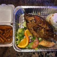 Mojarra al Ajo · Fried whole tilapia topped with garlic sauce served with white rice,seasoned fries, salad an...