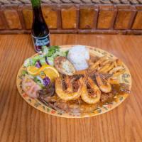 Mojarra la Playa · Fried whole tilapia topped with shrimp, mild spice house sauce and served with white rice,se...
