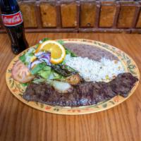 Carne Asada · Grilled inside skirt steak with onions, roasted chiles, white rice, beans, salad and tortill...