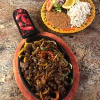 Fajitas de Carne · Steak fajitas served with salad, beans , white rice and tortillas. 