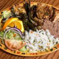 Pechuga de Pollo a la Plancha · Grilled chicken breast served with fried onions, fried chiles, beans, white rice, salad and ...