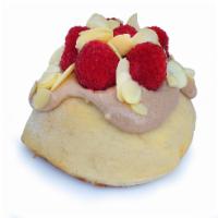Raspberry Dream Roll · chocolate frosting topped with raspberries and almonds