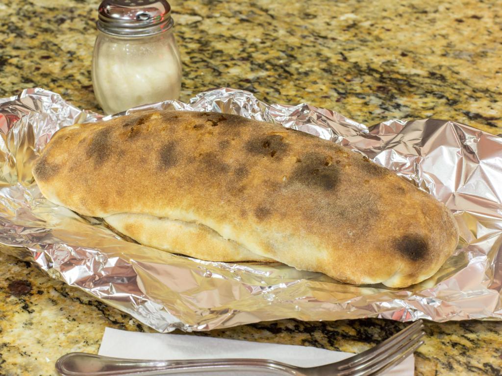 Stromboli · Stuffed with mozzarella, pepperoni, ham, salami, peppers and onions. Served with homemade sauce.