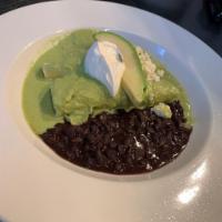 Enchiladas Verdes · Braised chicken breast, mole verde, avocado, sour cream, queso fresco and black beans 