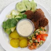 Falafel Platter · Scrumptious pita bread filled with Israeli salad, dill pickle chips and the purest falafel b...