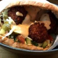 Whole Pita Falafel · Scrumptious pita bread filled with Israeli salad, dill pickle chips and the purest falafel b...