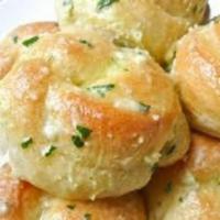 Garlic Knots · Freshly baked and tossed with a garlic and herb oil.