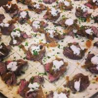 Flank Steak Flat Bread · Served with caramelized onions and horseradish cream sauce.