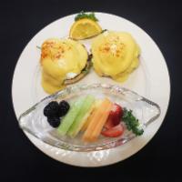 Veggie Benny · Two poached eggs, grilled tomato slices and spinach on an english muffin with hollandaise sa...