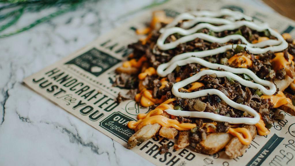 Philly Cheesesteak Loaded Fries · Beer battered fries topped with steak, green peppers, onions, nacho cheese, ＆ mayo
