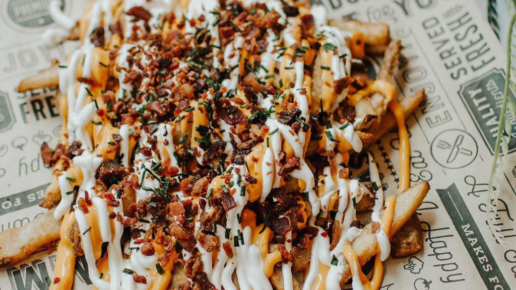 Baked Potato Loaded Fries · Beer battered fries topped with sour cream, bacon, nacho cheese, ＆ chives