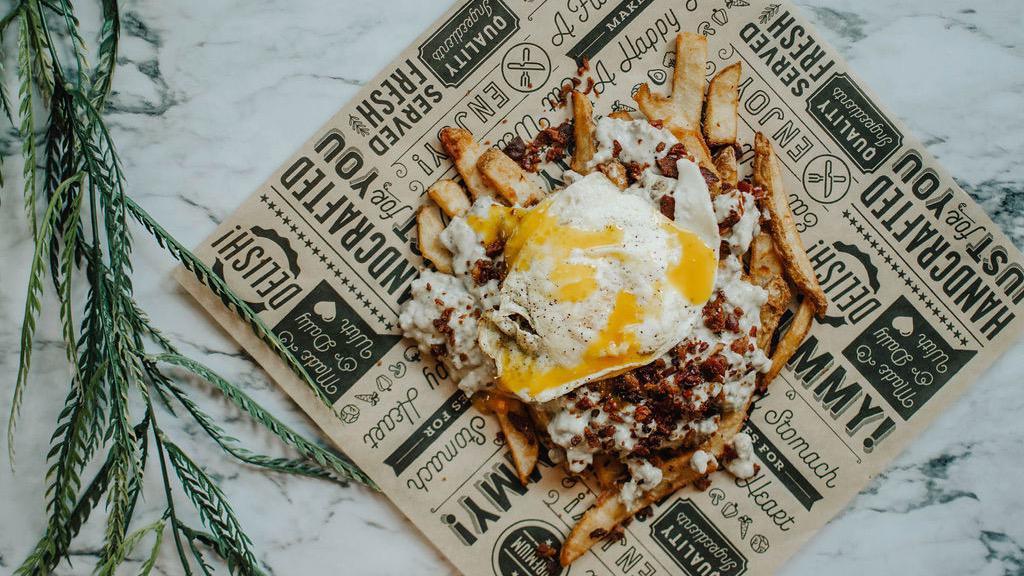 Breakfast Loaded Fries · Beer battered fries topped with sausage gravy, bacon ＆ a fried egg