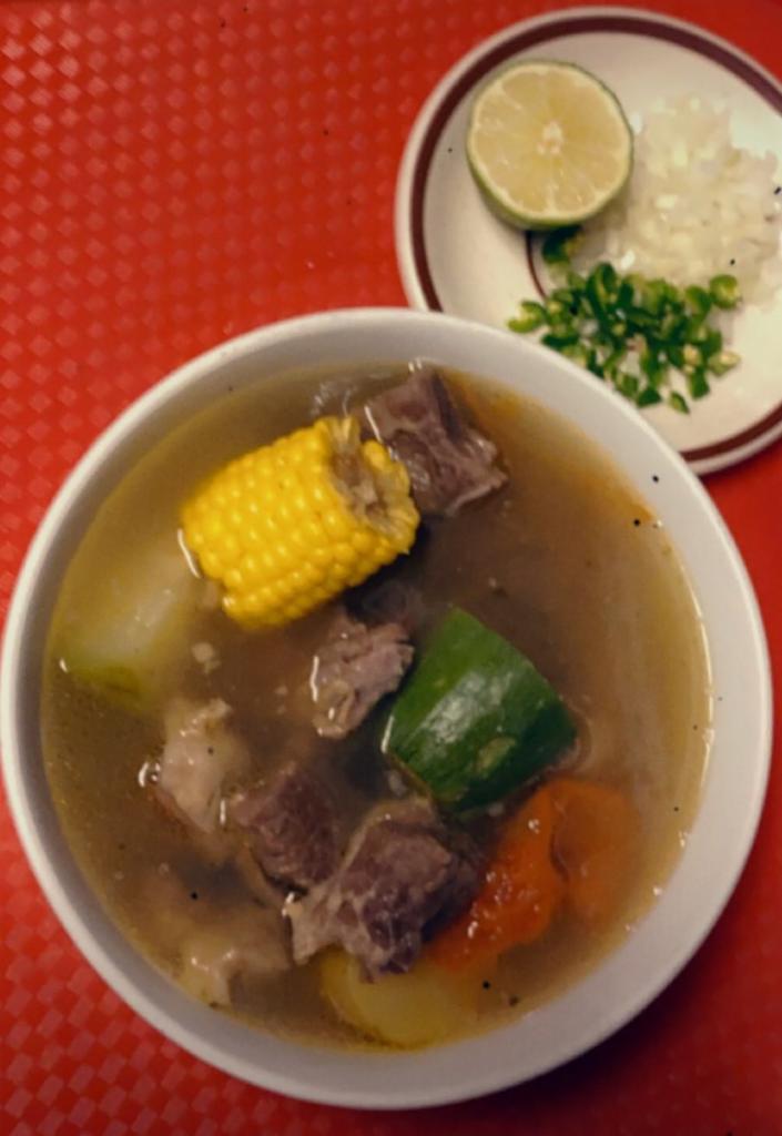 Caldo De Res · beef soup with vegetables and tortillas onions chile verde and lime on the side with side of rice