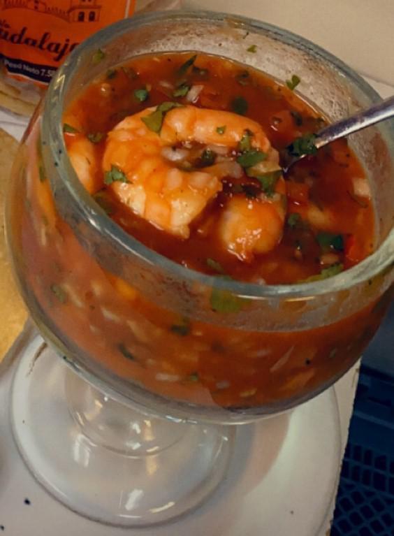 Coctel de Camaron · A soup with prawns, tomatoes onions avocado. No rice and no beans. ketchup tapatio lime and tostadas on the side 