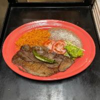 Carne Asada · Sliced skirt steak charbroiled, rice beans salad and guacamole on the side.