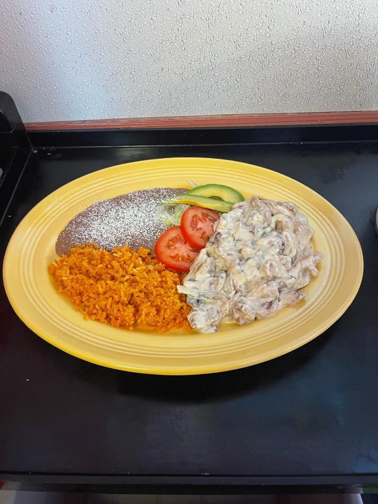 Pollo Crema  · Chicken in sour cream with mushrooms onions and bell peppers, rice & beans  