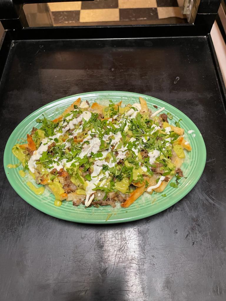 Asada fries  · fries meat cheese and cilantro  sour cream and guacamole 