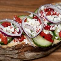 Mediterranean Toast · Hummus, cucumbers, feta cheese marinated peppers, red onion thinly sliced on multigrain toast.