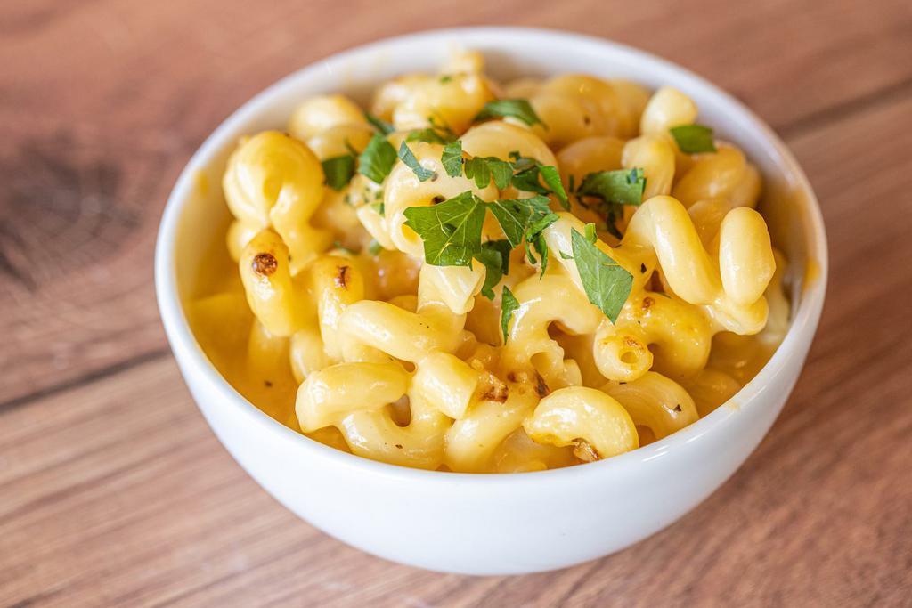 Mac & Cheese · Cavatappi pasta enveloped in a rich and creamy cheese sauce. Topped with a blend of shredded Parmesan cheese and bread crumbs and baked to perfection