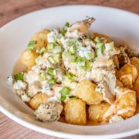 Buffalo Chicken Tots · Crispy tater tots topped with diced chicken, house-made creamy cheese sauce, green onions, b...